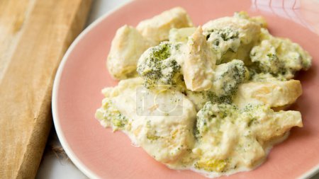 Photo for Baked chicken cooked with cream sauce and broccoli. - Royalty Free Image