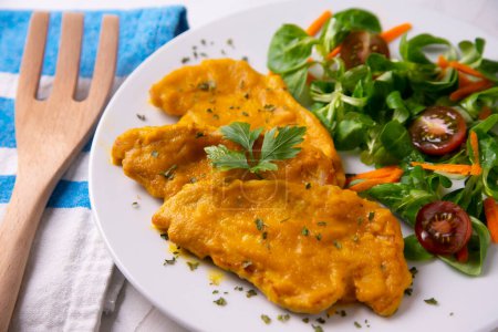 Photo for Chicken recipe with curry sauce and carrot. Served with rice and salad. - Royalty Free Image