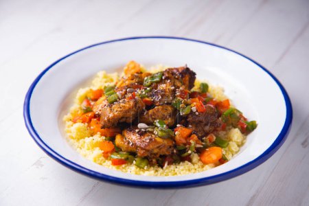 Photo for Marinated chicken with spices served on a plate with couscous. - Royalty Free Image