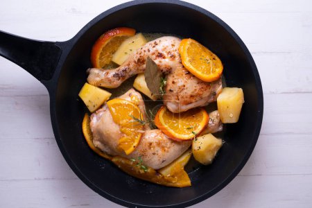 Photo for Braised chicken marinated with spices and orange sauce with potatoes. - Royalty Free Image