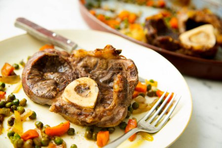 Photo for Baked beef ossobuco with vegetables. - Royalty Free Image