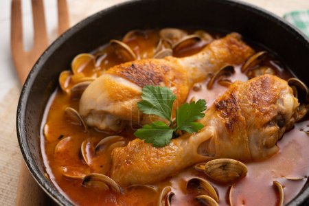 Photo for Baked chicken thighs cooked with clams and vegetables. - Royalty Free Image