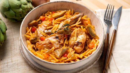 Photo for Baked noodles with rabbit and vegetables. Traditional Spanish tapa. - Royalty Free Image
