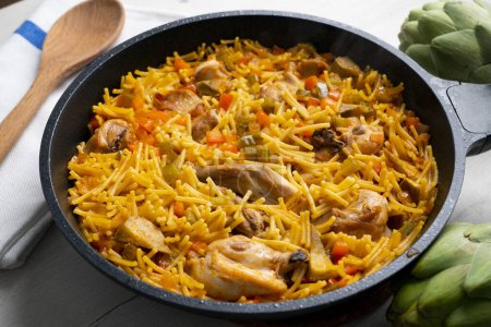Photo for Baked noodles with rabbit and vegetables. Traditional Spanish tapa. - Royalty Free Image