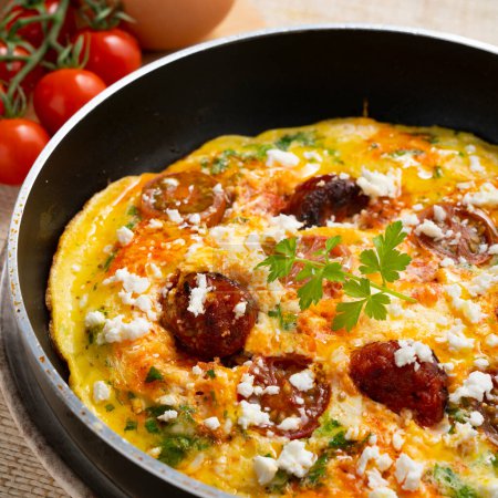 Photo for Frittata with chorizo. The frittata, from the Italian fritto, is a specialty of Italian cuisine similar to potato omelette and is usually filled with different ingredients such as vegetables, cheeses, sausages, mushrooms, etc. - Royalty Free Image