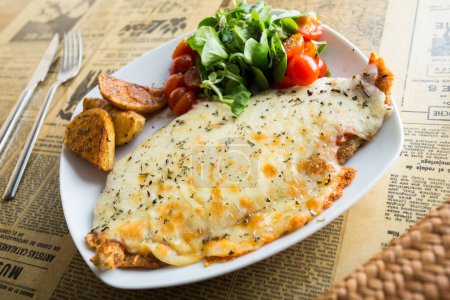 Photo for The milanesa is a fillet, usually beef, that is cooked fried or baked. By extension, any slice of an ingredient coated and cooked in a similar way is called milanesa - Royalty Free Image