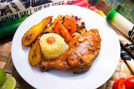 Grilled chicken cooked in Jamaican style with bananas and rice.