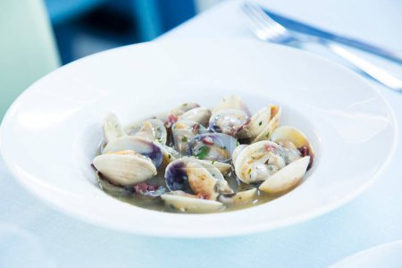 Photo for Steamed clams with white wine sauce and vegetables. Traditional Spanish tapa recipe. - Royalty Free Image