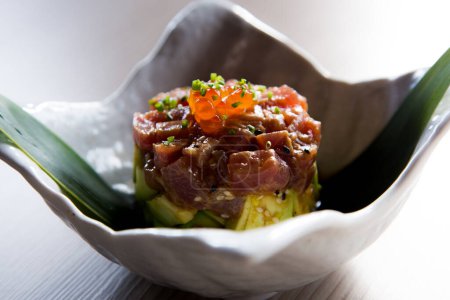 Photo for Tuna tartare marinated with soy. Tartare is a dish made from raw meat or fish, finely chopped, with a citrus (lime or lemon) and seasoned or flavored with spices and sauces. - Royalty Free Image