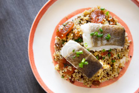 Photo for Baked cod cooked with quinoa. Traditional Spanish tapa recipe in the Basque country. - Royalty Free Image