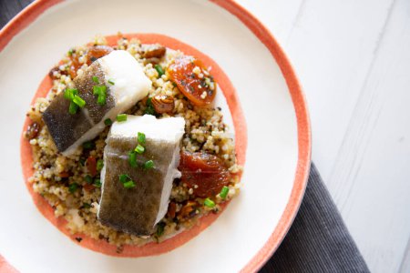 Photo for Baked cod cooked with quinoa. Traditional Spanish tapa recipe in the Basque country. - Royalty Free Image