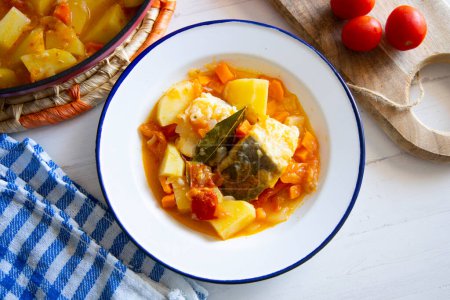 Photo for Baked cod cooked with potatoes and vegetables.. Traditional Spanish tapa recipe in the Basque country. - Royalty Free Image