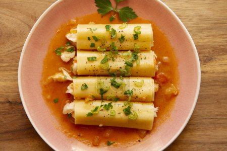 Photo for Fish cannelloni with hake and tomato sauce. - Royalty Free Image