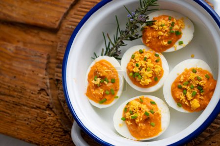 Photo for Boiled eggs stuffed with tuna and tomato paste. - Royalty Free Image