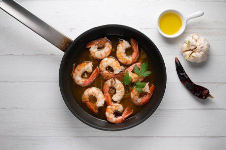 Photo for Traditional Spanish tapa of gambas al ajillo. Prawns cooked with olive oil and garlic. - Royalty Free Image