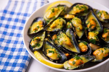 Traditional Spanish tapa of steamed mussels with orange sauce.