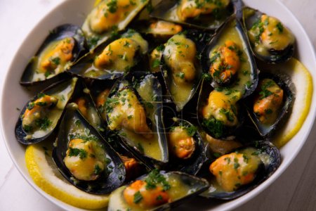 Photo for Traditional Spanish tapa of steamed mussels with orange sauce. - Royalty Free Image