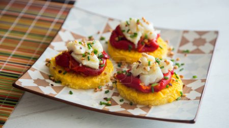 Photo for Fried polenta with cod and roasted red pepper. - Royalty Free Image