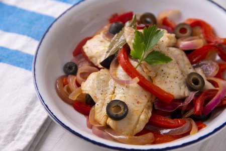 Photo for Fish cooked with onion and red pepper and black olives - Royalty Free Image