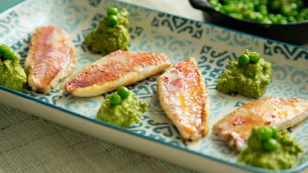 Photo for Red mullet with pea hummus. Traditional Spanish tapa recipe. - Royalty Free Image