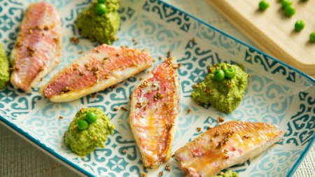 Photo for Red mullet with pea hummus. Traditional Spanish tapa recipe. - Royalty Free Image