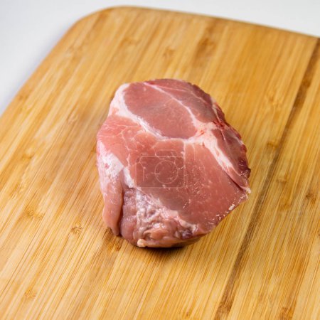 Photo for Prime pork loin on a wood on a white background. - Royalty Free Image