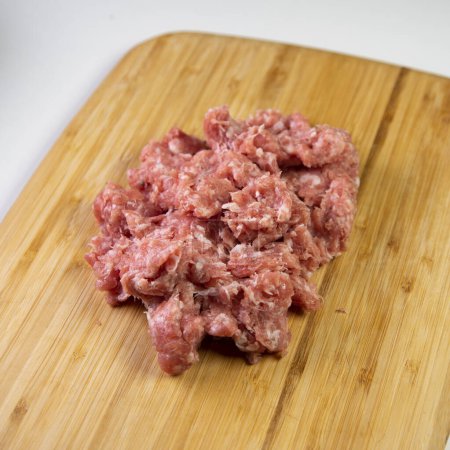 Photo for Premium minced pork on a wood on a white background. - Royalty Free Image