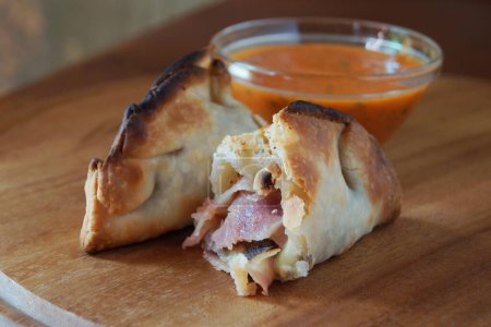 Photo for Argentinian empanada stuffed with ham and cheese. - Royalty Free Image