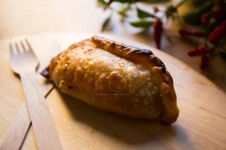 Photo for Argentinian empanada stuffed with beef meat and tomato. - Royalty Free Image