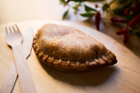 Photo for Argentinian empanada stuffed with beef meat and tomato. - Royalty Free Image