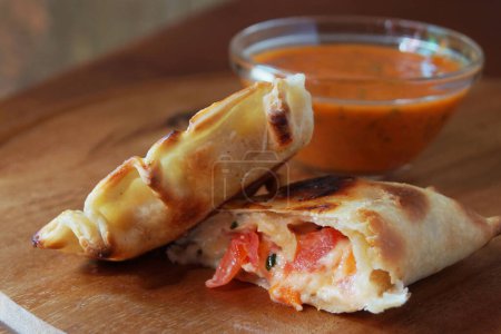 Photo for Carpresse Argentinian empanada stuffed with cheese and tomato. - Royalty Free Image
