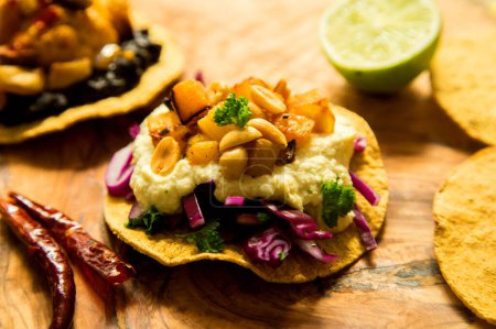 Photo for Tostada with hummus and corn, name given to various dishes in Mexico that include a toasted tortilla as the main base of its preparation. - Royalty Free Image