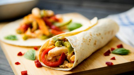 Photo for Chicken fajita. The fajita is one of the most traditional and popular dishes in Tex-Mex cuisine. It consists of meat roasted on the grill and cut into strips, served on a corn flour or wheat flour tortilla. - Royalty Free Image