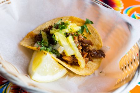 Photo for Taco with beef and pineapple. A taco is a traditional Mexican food consisting of a small hand-sized corn tortilla - Royalty Free Image