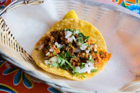 Photo for Pork taco. A taco is a traditional Mexican food consisting of a small hand-sized corn tortilla - Royalty Free Image