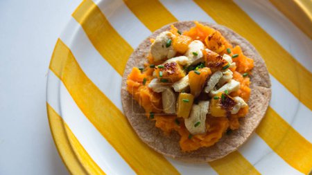 Photo for Chicken, pinneaple and sweet potato taco. A taco is a traditional Mexican food consisting of a small hand-sized corn tortilla - Royalty Free Image