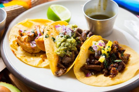 Photo for Three tacos. A taco is a traditional Mexican food consisting of a small hand-sized corn tortilla - Royalty Free Image