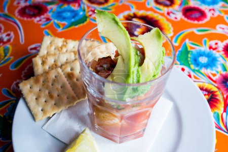 Photo for Ceviche served in a glass with some avocado on the top. - Royalty Free Image