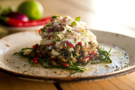 Photo for Ceviche with squid and lentils. Ceviche is a small traditional Latin American appetizer consisting of pieces of raw seafood or fish in an acidic marinade. - Royalty Free Image