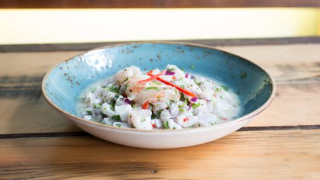 Photo for Ceviche is a small traditional Latin American appetizer consisting of pieces of raw seafood or fish in an acidic marinade. - Royalty Free Image
