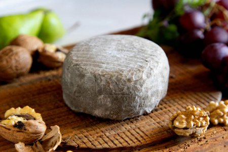 Photo for Organic Spanish artisan cheese on a wooden board. - Royalty Free Image