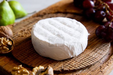 Photo for Organic Spanish artisan cheese on a wooden board. - Royalty Free Image