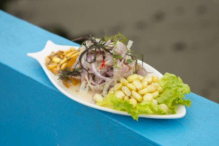 Photo for Preparing a delicious Peruvian sea bass ceviche in the fishing port of Chorros in Lima. - Royalty Free Image
