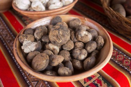 Photo for Variety of Peruvian potatoes. In the pachamanca ceremony, lamb, alpaca, pork and beef are cooked. Also variety of tubers and vegetables. All under hot stones and covered with earth. - Royalty Free Image