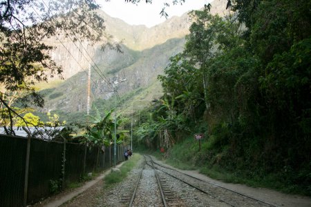 Photo for Hiking from Santa Teresa Hidroelctrica to Aguas Calientes to reach Machupichu. Path following the train tracks with several hikers. - Royalty Free Image