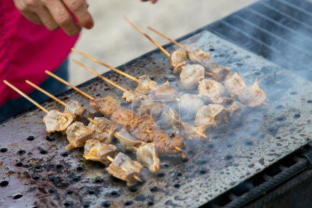 Photo for The anticucho is a type of skewer of Peruvian origin, which later became popular in South American countries with different variations. It consists of meat and other foods that are roasted on a skewer - Royalty Free Image