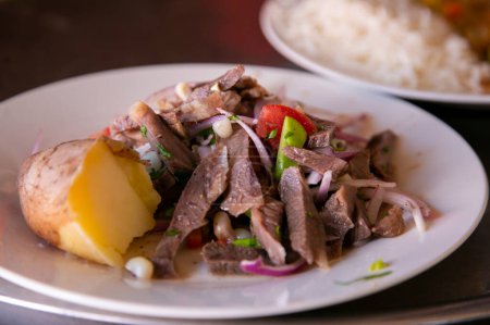 Photo for Sarsa de Sencca. Traditional Peruvian dish with beef served with potatoes and vegetables. - Royalty Free Image