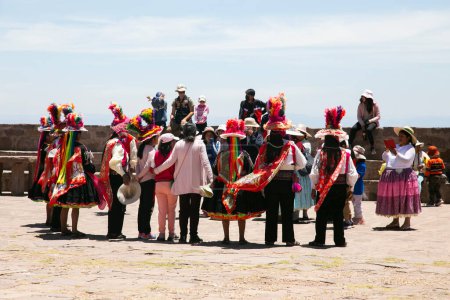 Photo for Taquile, Peru; 1st January 2023: Locals from the island of Taquile in Peru dancing and playing music at an event in the main square of the island. - Royalty Free Image