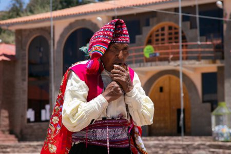 Photo for Taquile, Peru; 1st January 2023: Locals from the island of Taquile in Peru dancing and playing music at an event in the main square of the island. - Royalty Free Image