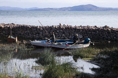 Photo for Taquile, Peru; 1st January 2023: Local fishermen from the Llachon peninsula working on the shores of Lake Titicaca. - Royalty Free Image